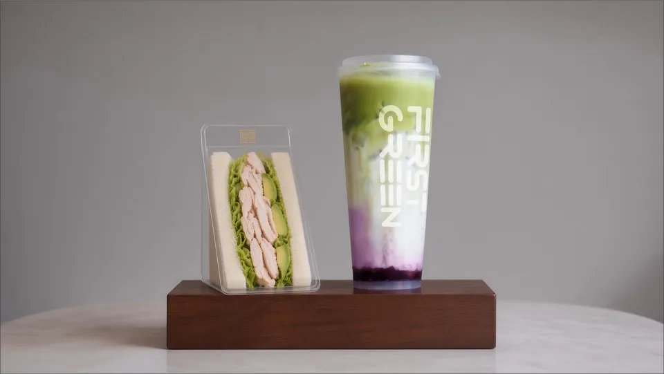 Japanese-style triangle sando beside a layered matcha drink